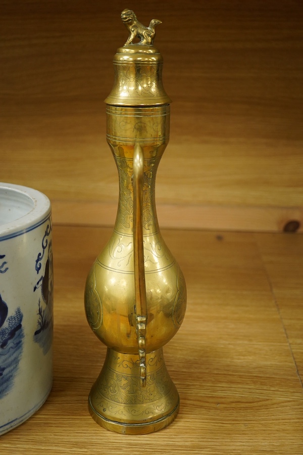 A Chinese cylindrical blue and white brush pot and a brass ewer, largest 39cm high. Condition - fair